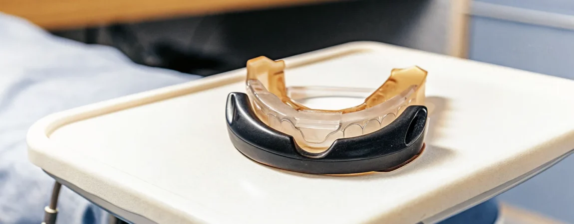 Custom-fitted oral appliance for sleep apnea on a medical tray in a clinical dental sleep medicine office