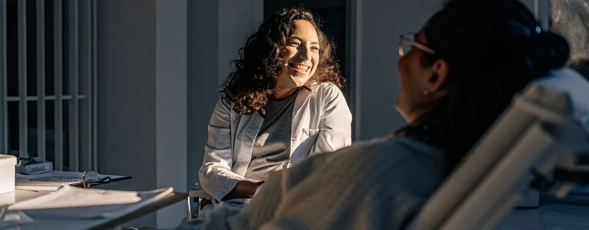 Patient and dentist discussing oral appliance therapy coverage in a bright Bay Area sleep medicine office
