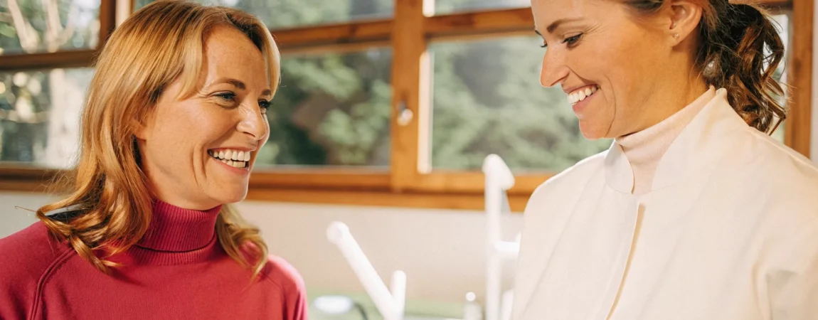 Older adult patient discussing oral appliance sleep apnea treatment with a dentist in a modern clinic